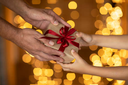 Christmas gift passed from hand to handの写真素材