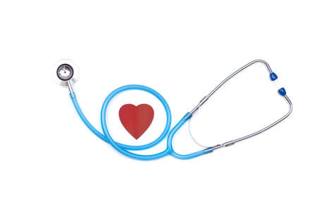 Meditsin stethoscope on a white background in the middle of a red heart, the concept of heart disease. High quality photoの写真素材