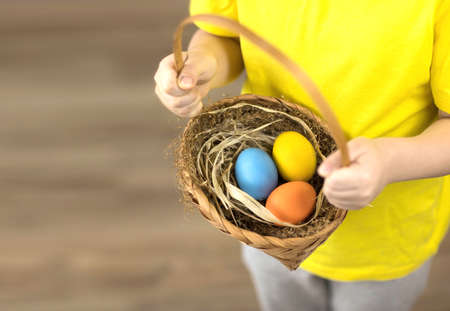 Easter colored eggs in a basket close-up