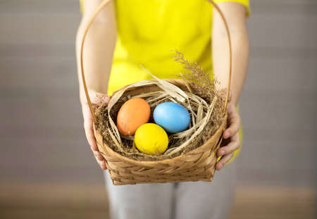 Easter colored eggs in a basket close-up