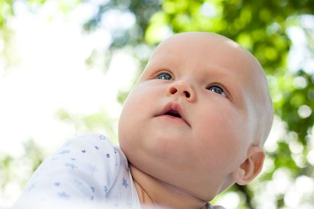 Little baby enjoying summer in a gardenの写真素材
