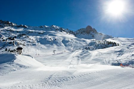 Fresh ski slope with snowcat tracks in Meribel Valley, French Alpsの写真素材