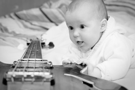 Four month baby girl and the bass guitar, black & white shotの写真素材