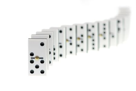 Chain of white domino stones on white background,  focus on firstの写真素材