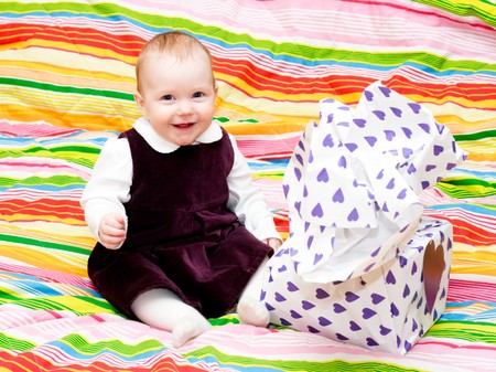 Happy eight month baby girl with wrapped gift