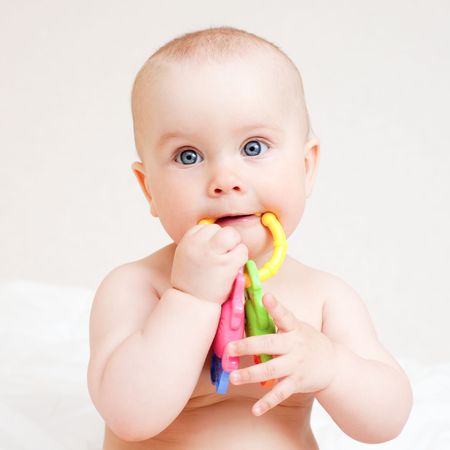 Little baby girl with teething toyの写真素材