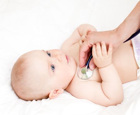 Children's doctor exams infant with stethoscopeの写真素材