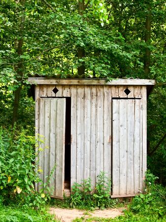 Old wooden outhouse in the forestの写真素材