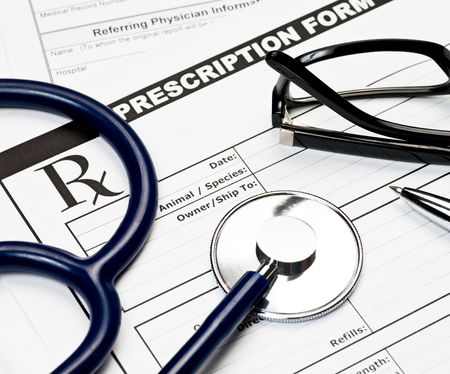 Blank veterinarian prescription form with stethoscope glasses and penの写真素材