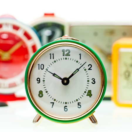 Vintage mechanical wind-up alarm clock  set on white backgroundの写真素材