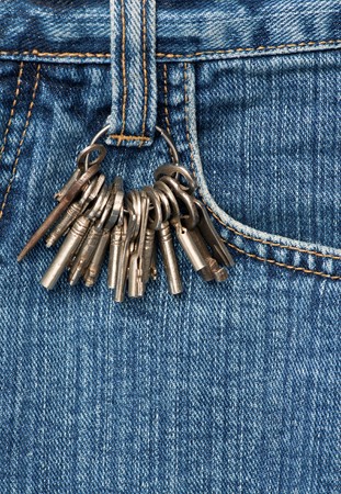 Bunch of keys on a blue jeansの写真素材