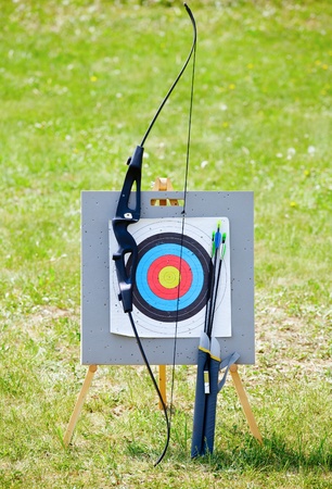Bow and arrows with archery target outdoorsの写真素材