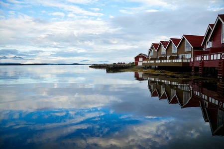 Red wooden cabins  at campsite by the fjord in Molde, Norwayの写真素材