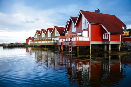 Red wooden cabins at campsite by the fjord in Molde, Norwayの写真素材