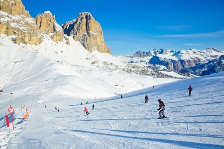Skiers going down the slope at Val Di Fassa ski resort in Italyのeditorial素材