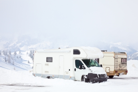 Snowed motorhomes at winter mountainsの写真素材