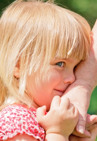 Granddaughter holding grandmother's hand closeupの写真素材