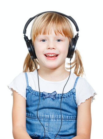 Portrait of cute 4 years girl wearing headphones over a white backgroundの写真素材