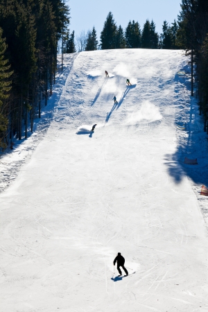 Skiers going down the slopeの写真素材