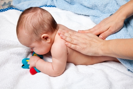 Masseuse massaging 5 months infantの写真素材