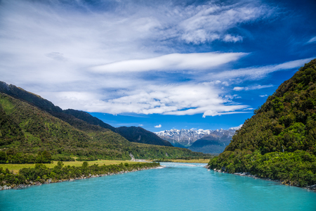 Milky blue glacial water of popular for whitewater rafting Whataroa River in New Zealandの写真素材