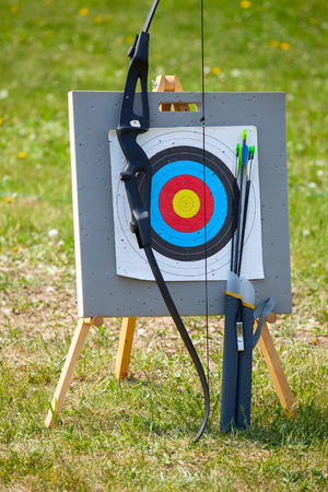 Bow and arrows with archery target outdoorsの写真素材