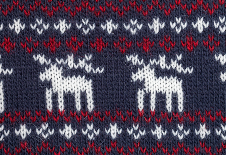 Deep blue knitted fabric with moose or elk ornamentの写真素材