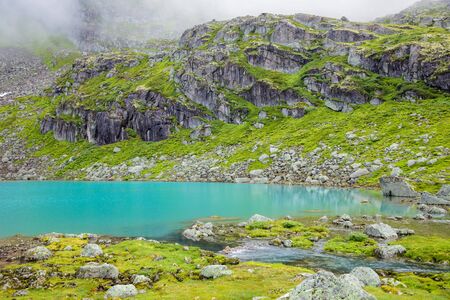 Small mountain lake with turquoise glacial water in Jostedalsbreen National Park Norwayの写真素材