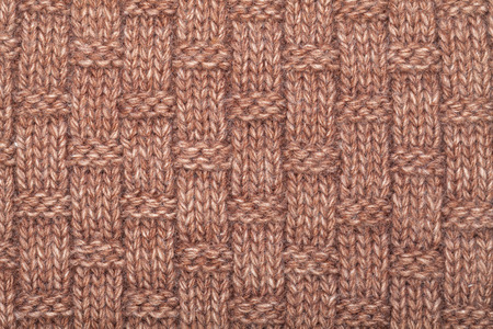 Brown knitted fabric made of heathered yarn textured background