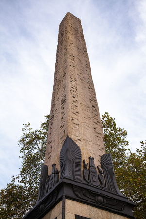 Ancient granite Cleopatra's Needle Egyptian obelisk with Egyptian inscriptions on Victoria Embankment in City of Westminster London UKの写真素材
