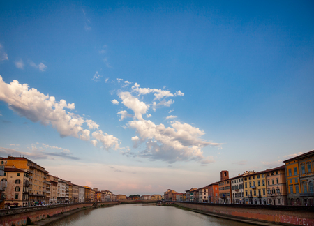 Pisa cityscape with medieval waterfront buldings on Arno River embankment, Tuscany, Italyの写真素材