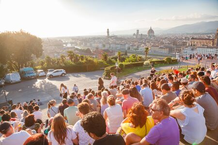 FLORENCE, ITALY - JUN 1, 2018: Tourists gather at Piazzale Michelangelo steps to enjoy spectacular sunset over Florence with Arno River, Ponte Vecchio and Florence Cathedralのeditorial素材