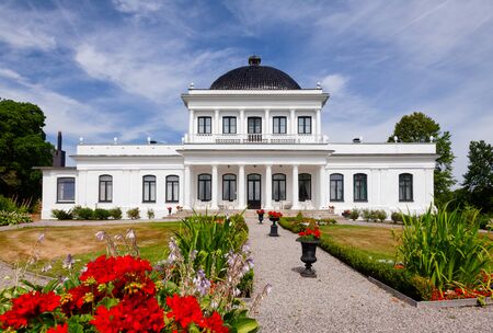 ULEFOSS, NORWAY - JULY 18, 2018: Facade of Empire-style Ulefos Manor House (Hovedgaard), a popular...