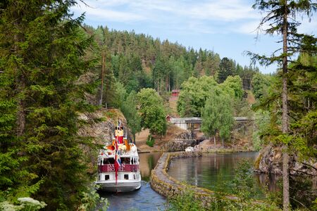 ULEFOSS, NORWAY - JULY 18, 2018: M/S Henrik Ibsen ferry boat at lower canal of the Vrangfoss lock during a unique historical boat trip through spectacular Norwegian nature by the Telemark Canalのeditorial素材