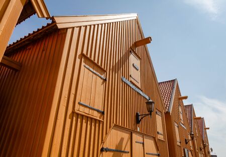 STAVERN, NORWAY - JULY 20, 2018: Ochre coloured historic barracks used as sloop and galley sheds at Fredriksvern Naval Base shipyard in Staverns Fortressのeditorial素材