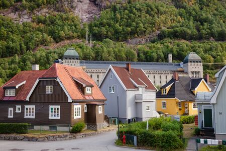 RJUKAN, NORWAY - JULY 14, 2018: Residental wooden houses with the Saheim Hydroelectric Power Station at background, Rjukan-Notodden UNESCO Industrial Heritage Siteのeditorial素材