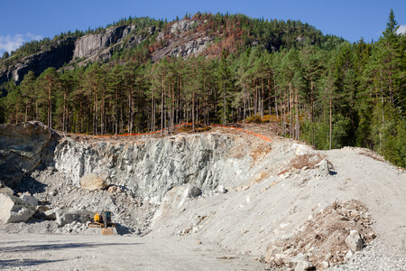 Excavator at small quarry in Norway, Scandinavia, mining construction aggregate and riprapの写真素材