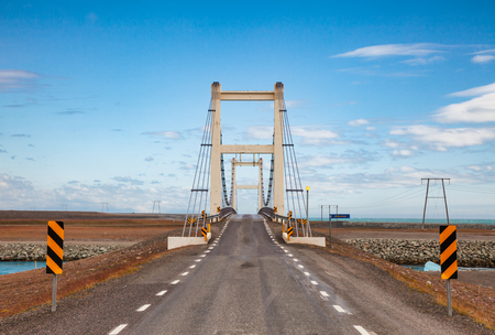 Suspension bridge over Jokulsa glacial river on Route 1 near Jokulsarlon glacial lagoon. Route 1 or Ring Road (Hringvegur) is a national road that runs around the island and connecs popular tourist attractions in Iceland, Scandinaviaの写真素材