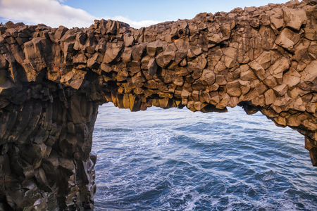 Natural basalt arch at Dyrholaey promontory near the village of Vik i Myrdal, a popular tourist attraction on the South Coast of Iceland, Scandinaviaの写真素材