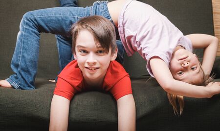 Siblings climbing the walls going mad stuck at home being in self-isolation.