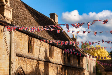 Union Jack flag bunting hanging in a street, a festive decorations in Southwest England, UK