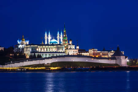 Illuminated Kazan Kremlin, historic citadel of Tatarstan, Russia, as viewed across the Kazanka river at nightの写真素材