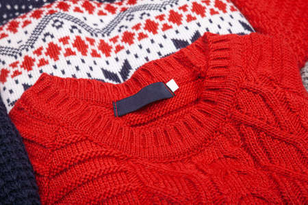 Various knitted sweaters in a clothes store close-up