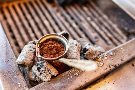 Brewing a turkish style coffee in brassy cezve on a charcoal stove in traditional method on a street of Istanbul, Turkeyの写真素材