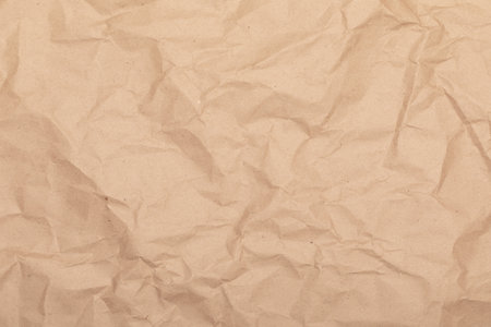 Sheet of brown wrinkled kraft made from recycled paper with texture and detailsの写真素材