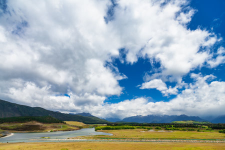 Dramatic sky over the Mararoa River, one of the braided rivers of the Southland Region of the South Island of New Zealandの写真素材