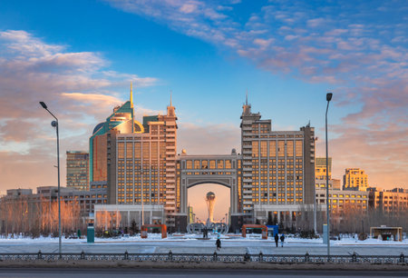 Astana winter cityscape with KazMunayGas oil and gas company of Kazakhstan headquarters and Bayterek Tower seen thru the archのeditorial素材
