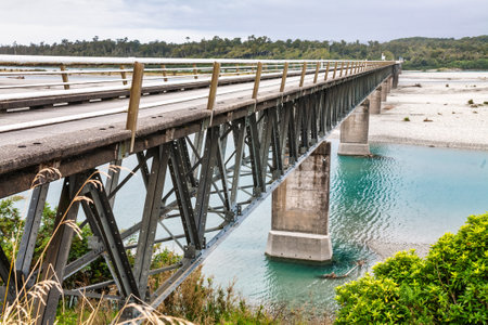Single lane deck truss bridge over the Haast River on the West Coast of the South Island of New Zealandの写真素材
