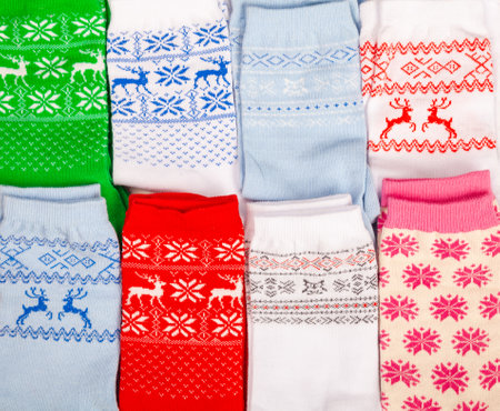 Various socks with nordic geometric ornament lay folded