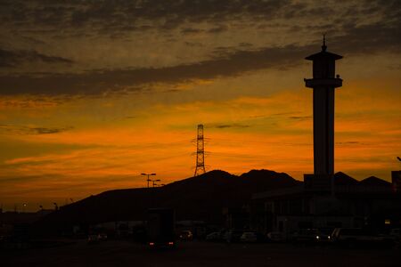 Sunrises in Saudiarabia, beautiful orange sky with minaret and mountainの写真素材